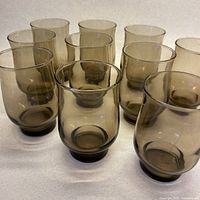 front view of ten smoky grey tulip glasses