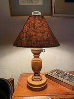 full view of wooden table lamp with shade on desk