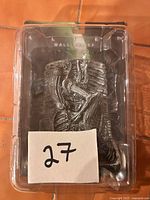 Front view of sealed Alien wall relief in packaging showing sculpt detail and branding