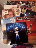 group shot of all nine Barry Manilow LPs