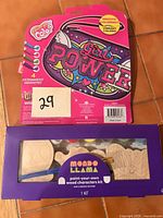 Front view of Girl Power color-your-own handbag package atop Mondo Llama wood character kit box