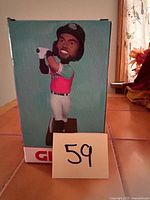 Front view of boxed Darrick Hall bobblehead showing figure image and lot number card