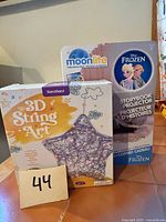 Both boxed items: projector set and string art kit
