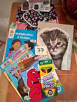 Overall lot showing backpack, activity books, colored pencils