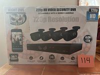 Front of box showing DVR, four cameras, 720p resolution, 8CH, 1TB