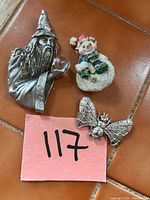 Group shot of all three costume pins: wizard, snowman, bee