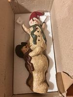 Figurine inside box showing overall shape and color details