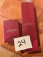 Two red Glam & Glow boxes closed