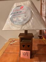 Lamp with shade wrapped in plastic