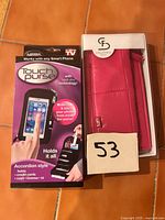 Front view of boxed Touch Purse and boxed Stella & Fritz wallet