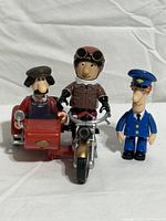 Group view of three figures and motorbike with sidecar