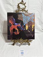 Front jacket of David Bowie "Let's Dance" LP on stand
