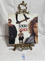 Front jacket of INXS Kick vinyl LP on stand