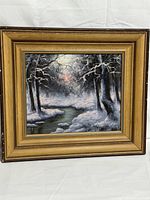 Front view of framed winter landscape painting