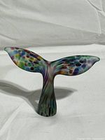 Front view of frosted glass whale tail showing multicolor pattern