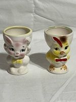 Front view of both ceramic egg cups, rabbit and chick