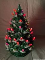 Tree illuminated showing multicolour bulbs and snow accents