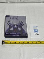 Front view of sealed steelbook with measuring tape