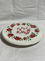 Top view of cake stand showing Happy Birthday design and roses