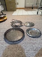 Overview of all four silver-plated items on carpet