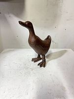 Full view of carved wooden duck sculpture front angle