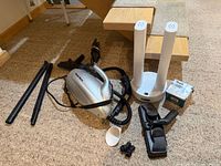 All items laid out: steamer body, hose, extension tubes, attachments, dryer stand, filter box
