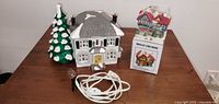 Overall lot showing house, tree, cottage with box, and plug-in cord