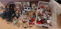 Wide view of tote full of assorted ornaments, boxed ornaments and string lights