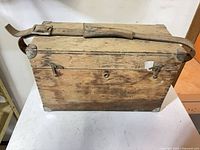 Top view of wooden case with leather strap attached