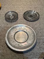 Group shot of all three silver-plated pieces on carpet