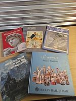 All five hardcover art books spread out on tabletop