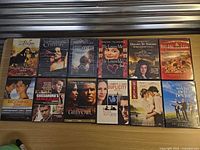 All 13 DVD cases laid out in two rows on tabletop