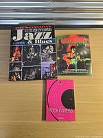 Front covers of the three books laid out on a table