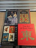 Front covers of all four art books laid flat