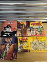 Front covers of five of the six comic books/graphic novels laid on tabletop