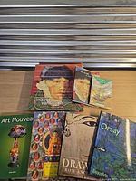 All seven books laid out, titles and covers visible