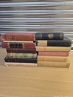 Side view of all eleven stacked hardcover books