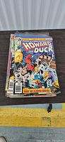 Front view of stack showing top issue Howard the Duck #25 (30¢)