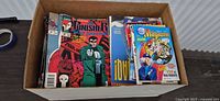 Top view of box showing Punisher War Journal comics, Sports Illustrated for Kids and other magazines