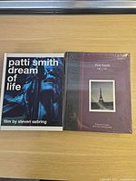Front covers of both Patti Smith hardcover books, one sealed