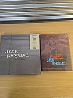 Front view of sealed box set and sealed book on tabletop