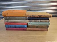 Side view of all ten cloth-bound books stacked horizontally