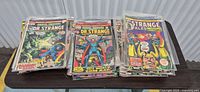 Three stacks of Doctor Strange related Marvel comics on table