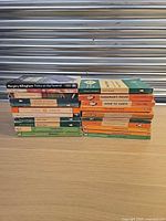Two stacks of nineteen vintage Penguin paperback books