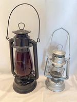 Both lanterns front view showing size difference, finishes and globes