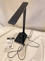 Lamp upright with manual and USB cable visible