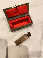 Seal beside open presentation box showing red interior