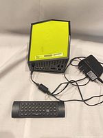 Boxee Box top view with remote and power adapter visible