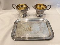 front view of creamer, sugar bowl, tray