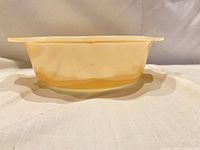 Side profile showing peach luster exterior and handle